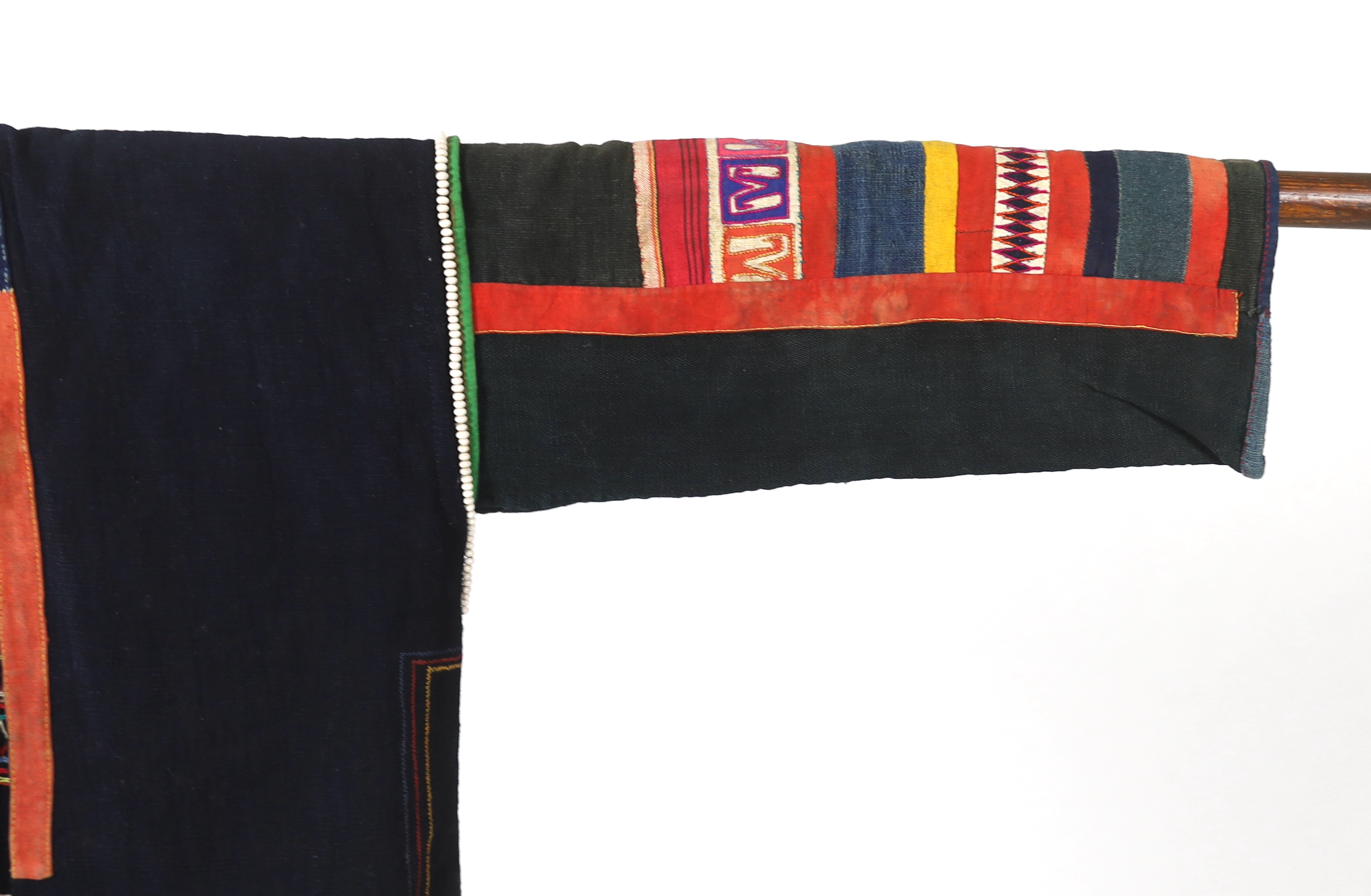 A Chiang Mai (Thailand) embroidered ladies three quarter length jacket, embroidered in hand dyed polychrome threads, (HKHA jacket) with beaded borders and spot design on a hand woven linen, 79cm long from neck to base